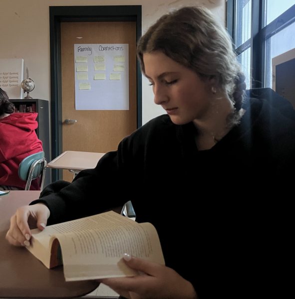 Sophomore Tenley Winn reading her favorite banned book, Looking for Alaska by John Green.